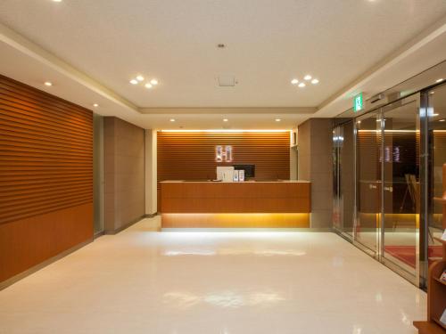 a lobby of a hotel with a waiting room at Business Hotel Isesaki Heisei Inn in Isesaki