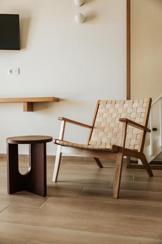 a wooden bench and a table in a room at Paralos The Maxine Adults Only in Agia Galini