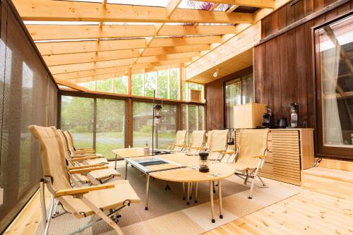 a room with a table and chairs in a house at Nature Cottage Akabeko in Kitashiobara