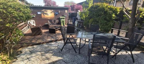a patio with a table and chairs in a yard at spacious room with free parking in Almere