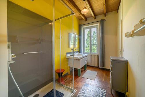 a bathroom with a glass shower and a sink at La Maison de Beaugas - Avec piscine dans le pays des bastides in Beaugas
