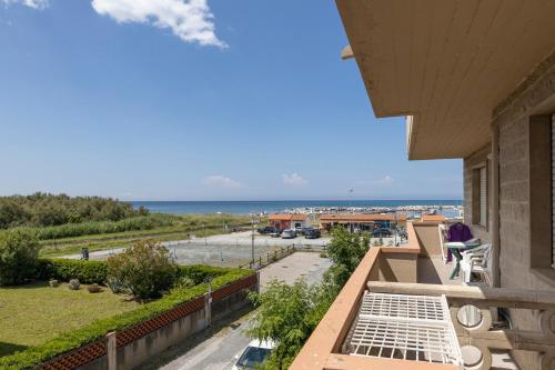 a balcony with a view of a parking lot and the ocean at Hotel Quisisana in Vada