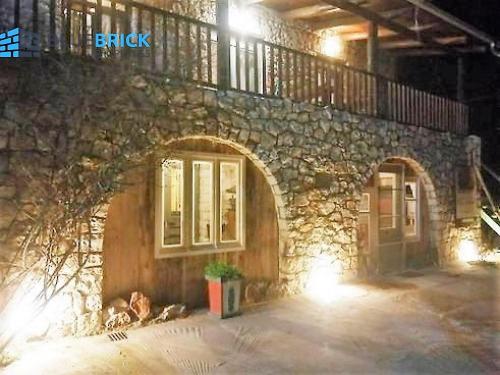 a stone building with an archway in front of it at Yono's Traditional House in Áno Ravénia