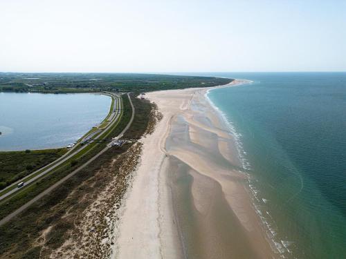 an aerial view of a beach next to the water at Glamping Kamperland in Kamperland