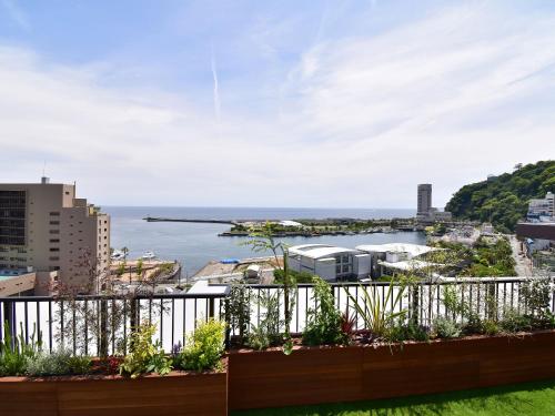 a balcony with a view of the water at Rakuten STAY Atami in Atami