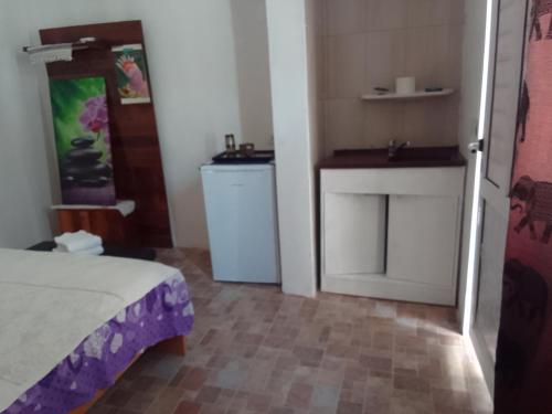 a bedroom with a bed and a sink in a room at Gradina 5 elemente in Eforie Nord