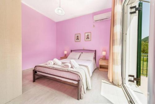 a bedroom with purple walls and a bed at Irene's Olive Guest house in Sami