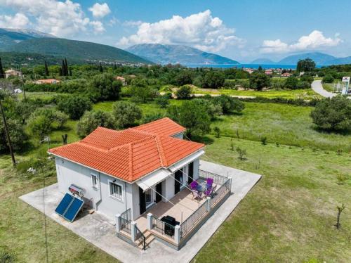 an overhead view of a small white house with an orange roof at Irene's Olive Guest house in Sami
