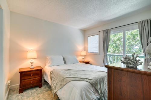 a bedroom with a bed with two lamps and a window at Myrtle Beach Resort Condo - Walk to Beach! in Myrtle Beach
