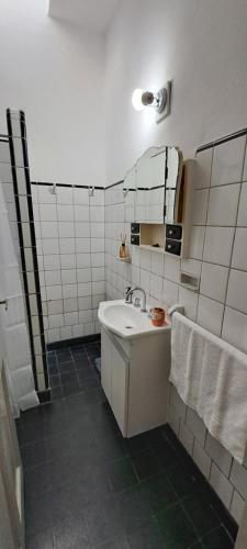 a white bathroom with a sink and a mirror at Sueño Cumbre. Casa Lavanda in La Cumbre