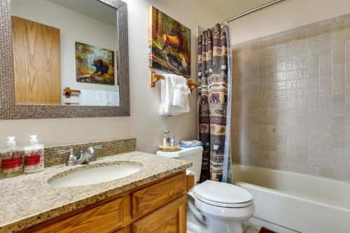 a bathroom with a sink and a toilet and a mirror at Cozy Condo with Balcony and Mtn View in Silverthorne! in Silverthorne