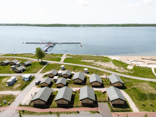 an aerial view of a group of resorts by the water at Glamping Schotsman in Kamperland