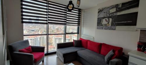 a living room with a couch and two chairs and a window at Tips For istanbul in Istanbul