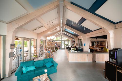 a living room with a blue couch and a counter at Glamping Callantsoog in Callantsoog