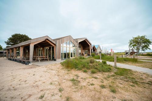 a house is being constructed in a field at Glamping Callantsoog in Callantsoog