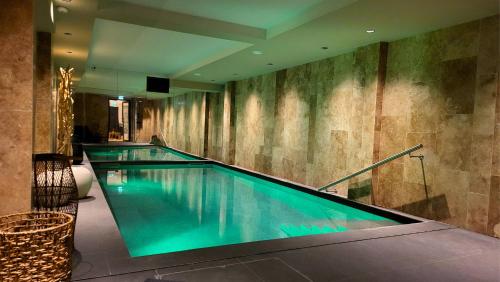 a swimming pool in a hotel with blue water at Star Champs-Elysées in Paris