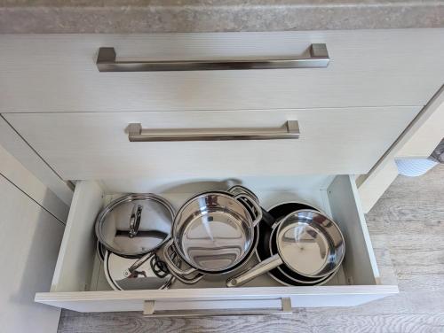 a drawer filled with pots and pans in a kitchen at Restaurace a penzion Gansberg in Cotkytle