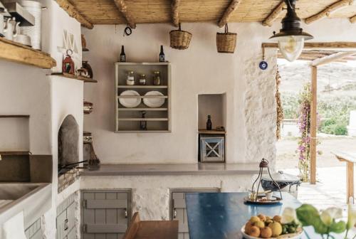 a kitchen with a counter with a blue counter top at Rizes Mykonos - Folklore Farmstead in Mýkonos City
