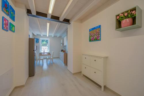 a hallway with a kitchen and a dining room at Tulipano Apt - Palazzo Palermo 1817 - Happy Rentals in Salionze