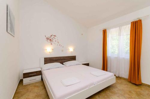 a bedroom with a white bed and a window at Apartment in Crikvenica with One-Bedroom 3 in Crikvenica