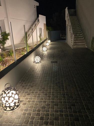 a row of lights on a sidewalk at night at RHODIAN TREASURE Spiridione apartment in Rhodes Town