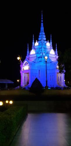 a building lit up in blue at night at Khwahol Guesthouse in Don Sak