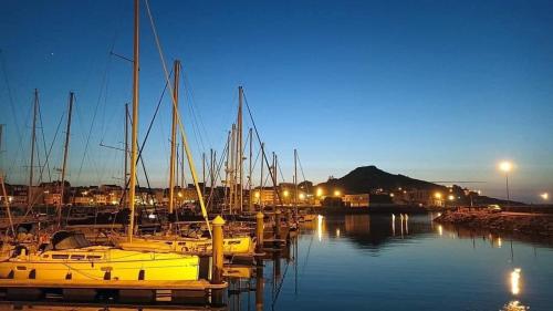 a group of boats docked in a marina at night at Muxia Costa da Morte in Muxia