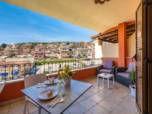 a balcony with a table and a view of a city at B&B Simius Bay in Villasimius
