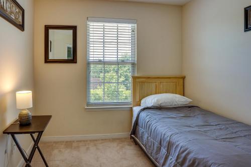 a bedroom with a bed and a table and a window at Spacious Mechanicsville Townhome with Balcony! in Mechanicsville