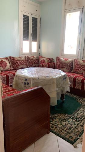 a living room with a table and a couch at Mohammedia in Mohammedia