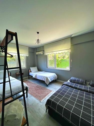 a bedroom with two beds and a bunk bed at HAN HOUSE SAPANCA in Sapanca