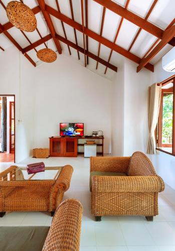 a living room with two chairs and a table at Captain Hook Resort @Koh Kood in Ko Kood