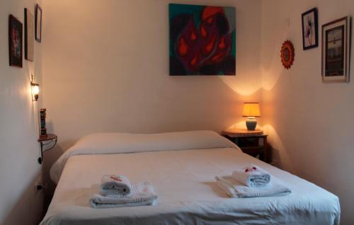 a bedroom with two beds with towels on them at Guesthouse Runcini in Ferentillo