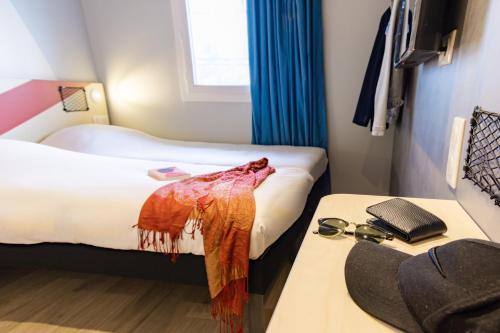 a hotel room with two beds and a sink at ibis Budget Villemomble in Villemomble