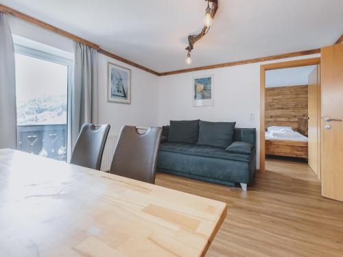 a living room with a couch and a table at Apartment Bauernhof Birkhöfl by we rent in Zell am See