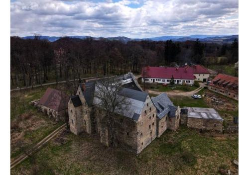 an aerial view of an old building in a field at Maciejowiec Castle Hill Apartment I in Maciejowiec