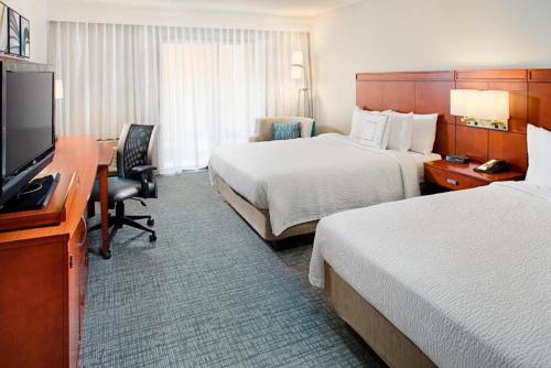 a hotel room with two beds and a desk at Courtyard by Marriott Tucson Williams Centre in Tucson