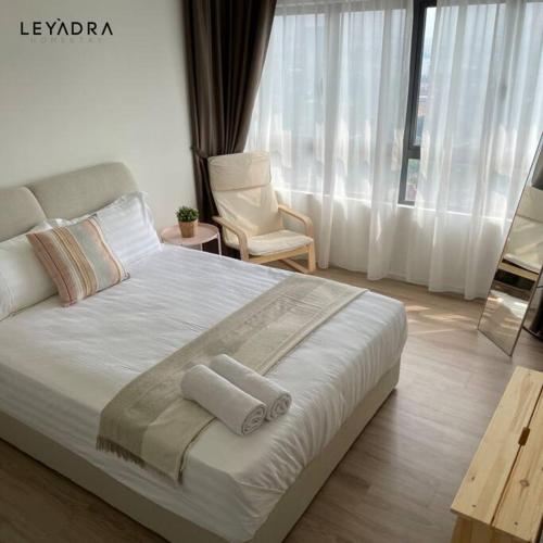 a bedroom with a large bed with two towels on it at Sunway Gandaria 3BR Full AC w/ Pool Wi-Fi Netflix in Bandar Baru Bangi