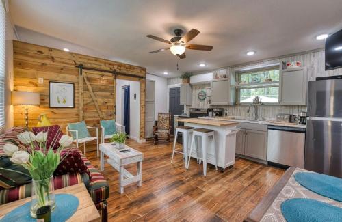a kitchen and living room with a couch and a table at Blue Bungalow Lake Hamilton in Hot Springs