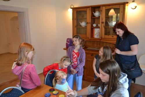 a group of children standing around a table at Penzion U Babky bylinkářky in Kutná Hora