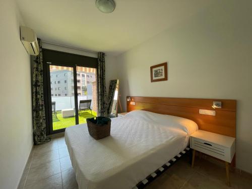 a bedroom with a large bed and a window at Apartamento renovado cerca de la playa in Lloret de Mar