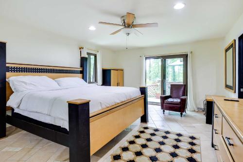 a bedroom with a large bed with a ceiling fan at Spacious King of Prussia Home with 2 Game Rooms in King of Prussia