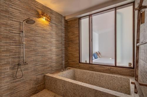 uma casa de banho com uma banheira grande e uma janela em Wendy the Pool Resort @ Koh Kood em Ko Kood