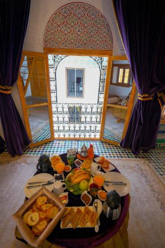 a table with food on it in a room at Riad Sahraui in Fès