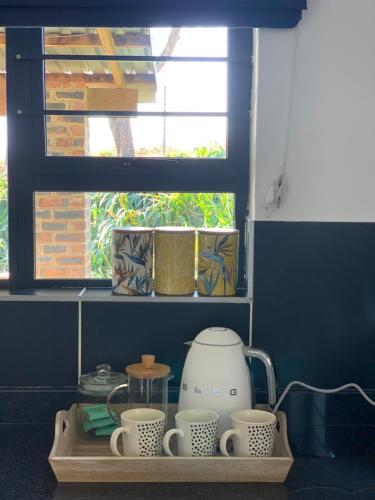 a shelf with three cups and a blender on it at Belvidere Country Estate in Karkloof Nature Reserve