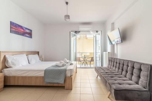 a bedroom with a bed and a couch at Urban Apt Next University 14 in Heraklio