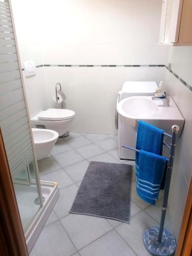 a white bathroom with a sink and a toilet at Emi Home in Montesilvano