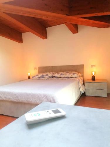 a bedroom with two beds and a table with a remote control at Emi Home in Montesilvano