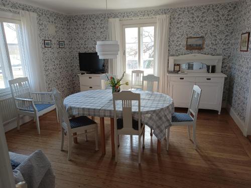 a dining room with a table and chairs at Sparreholm Bed and Breakfast in Sparreholm