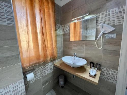 a bathroom with a sink and a mirror at The Queen Tropea in Tropea